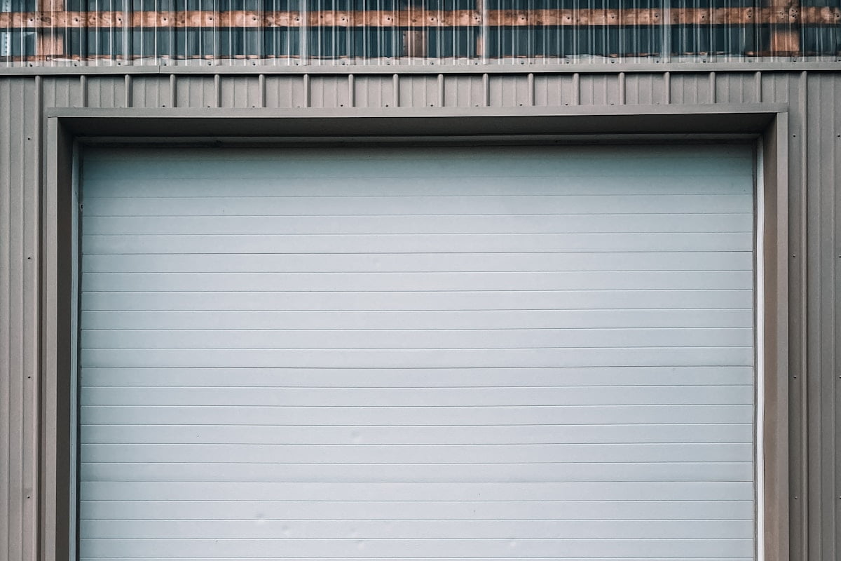 A roll-up garage door closed, the slats running the width of the opening.