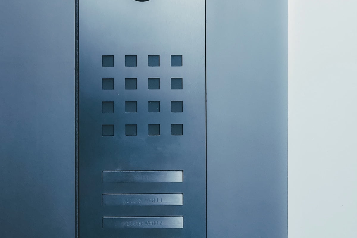 A multi-unit entry panel, one call button per flat, at the entrance to a block.